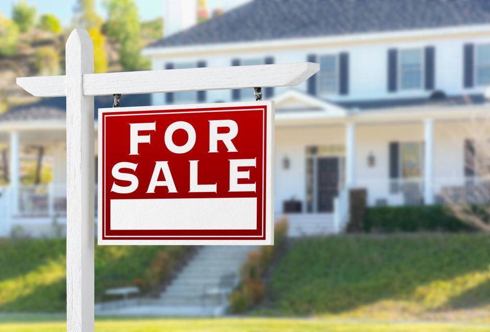 A Sign Stands in the Foreground of a Lawn — Richardson Conveyancing In Wollongong, NSW
