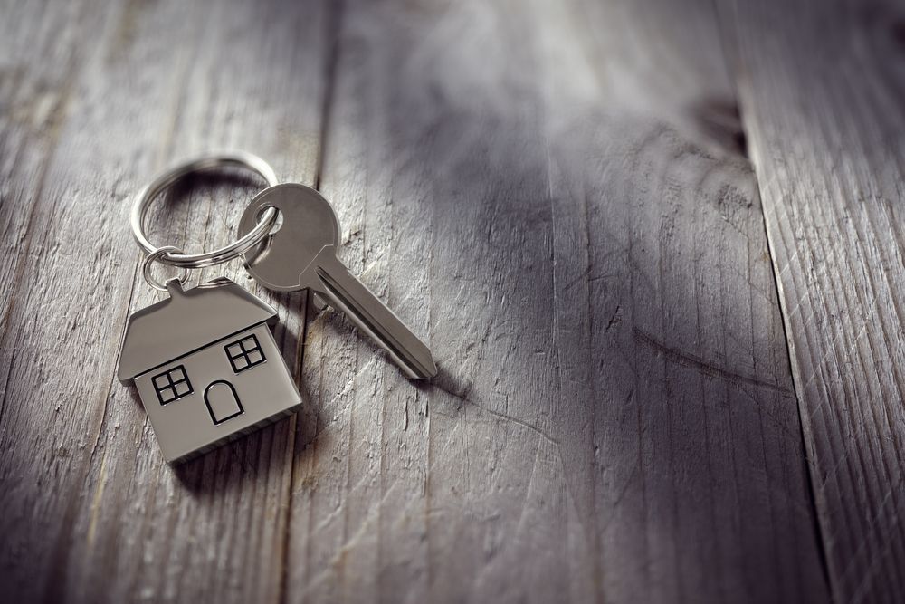 A Metal Key With a House-shaped Keychain Sits — Richardson Conveyancing In Wollongong, NSW