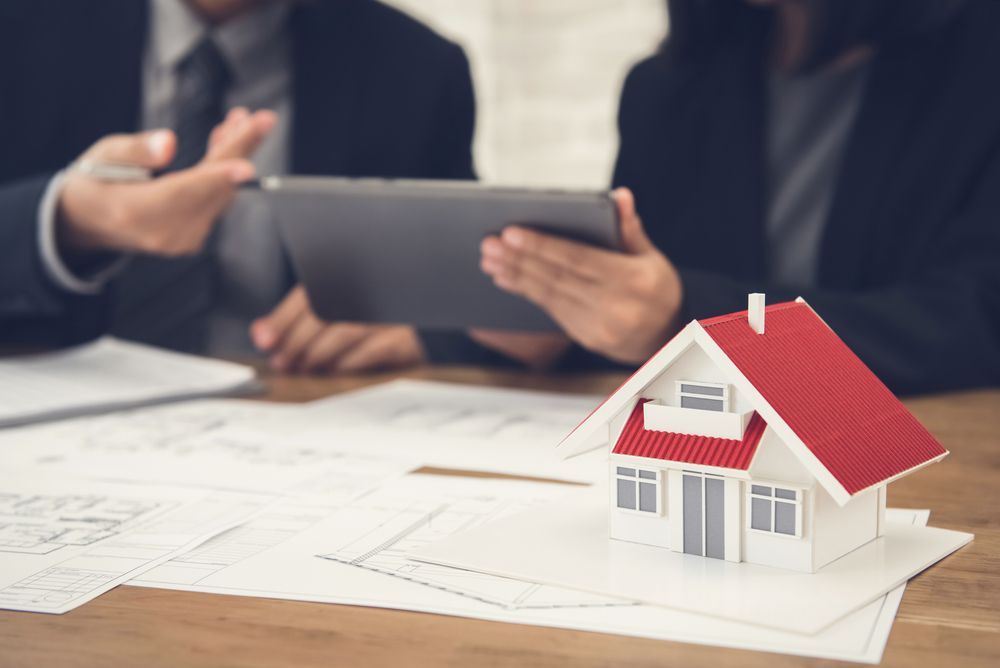 Business Professionals in Suits Use a Tablet — Richardson Conveyancing In Wollongong, NSW