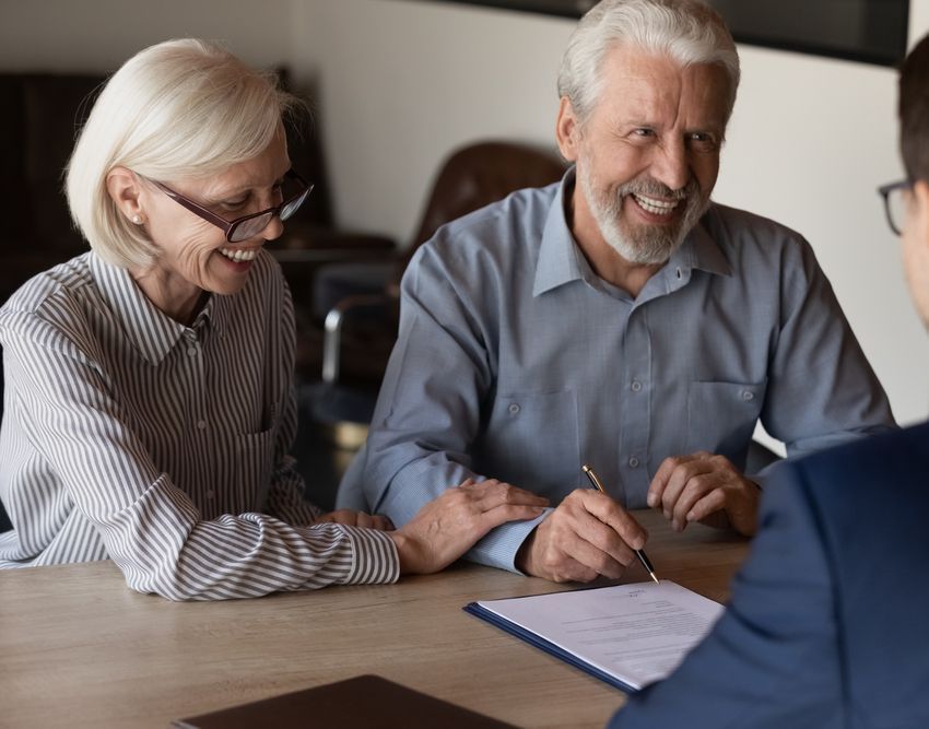 Two People Sit at a Table — Richardson Conveyancing In Tumbi Umbi, NSW