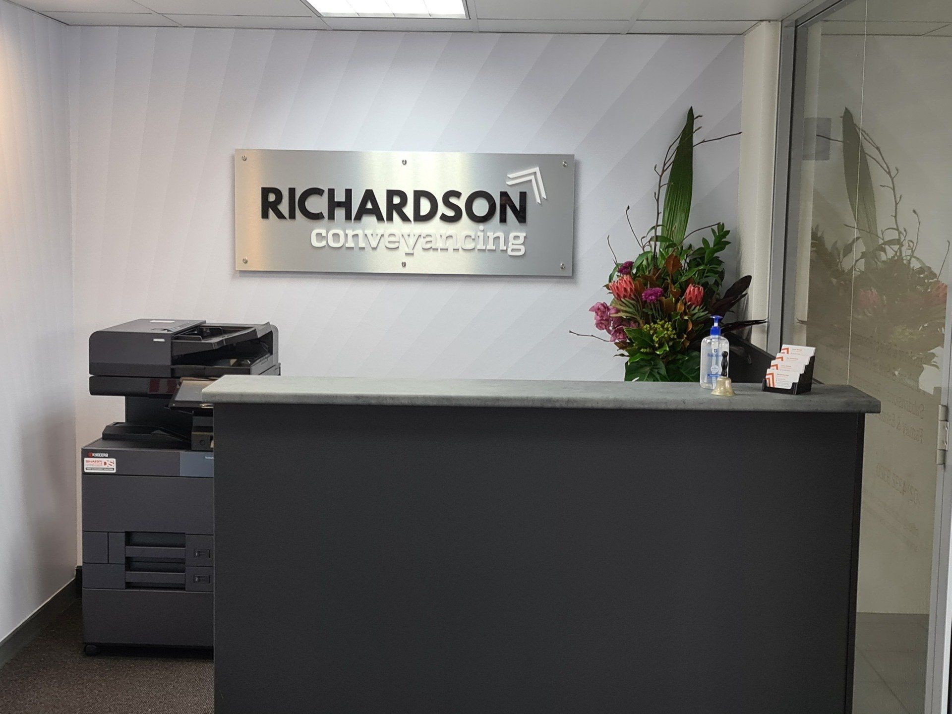 A Reception Desk for Richardson Conveyancing, Featuring a Black Counter — Richardson Conveyancing In Tumbi Umbi, NSW
