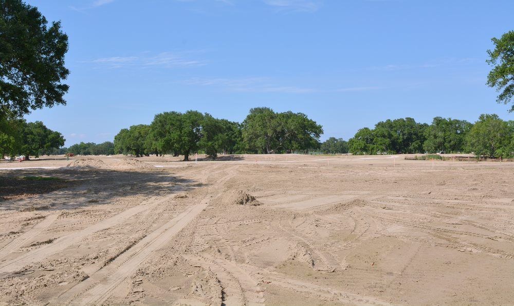 A Landscape of Cleared, Sandy Dirt With Tire Tracks in the Foreground  — Richardson Conveyancing In Tumbi Umbi, NSW