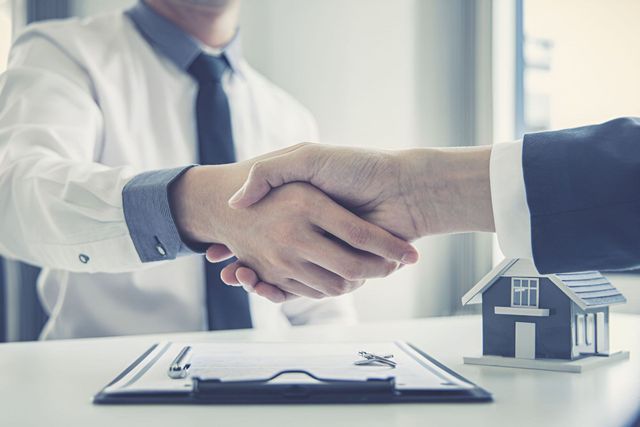 Two People in Business Attire Shake Hands — Richardson Conveyancing In Tumbi Umbi, NSW