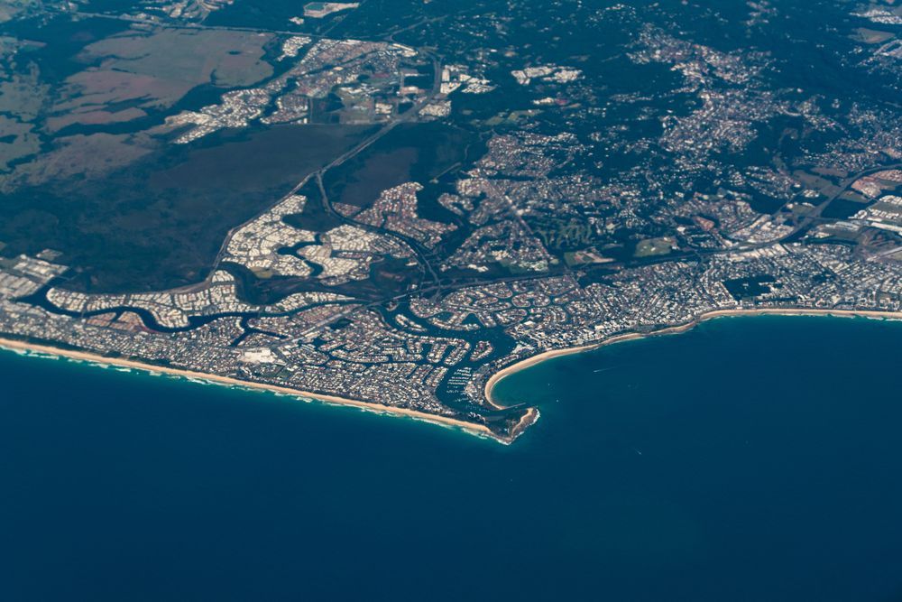 An Aerial View Of A City Next To A Body Of Water — Suncoast Termite & Pest In Kawana Waters, QLD