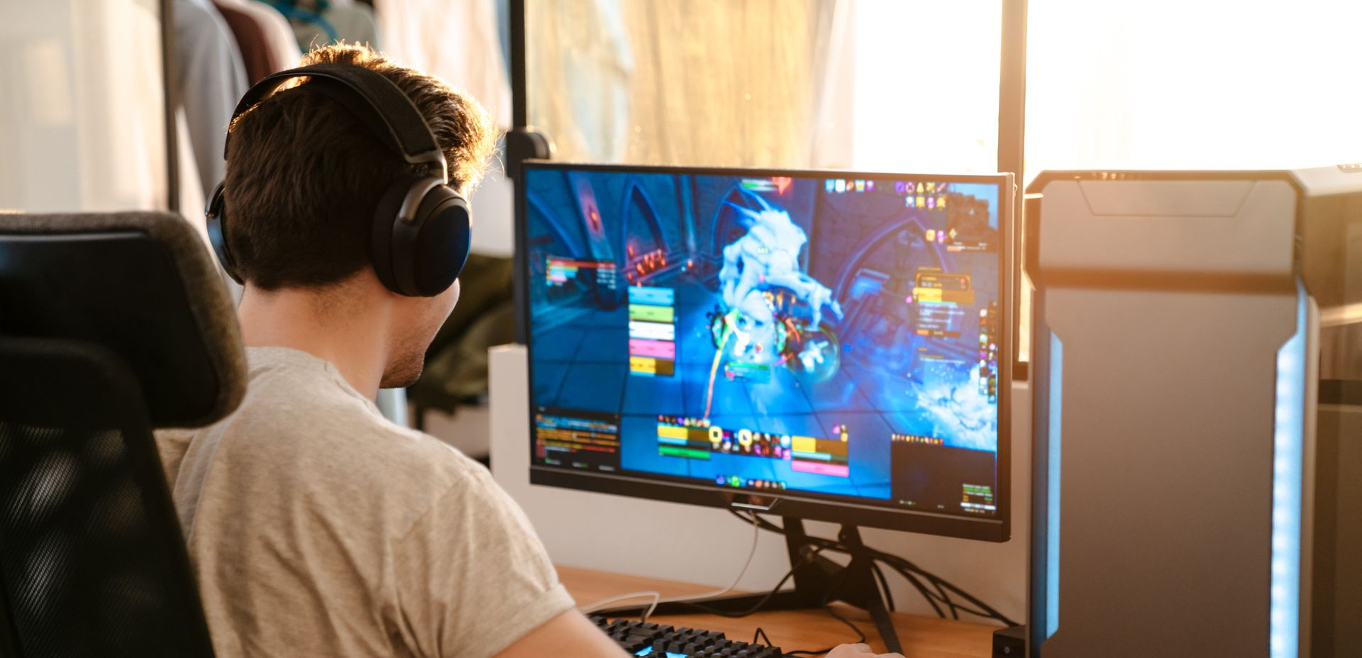 White router with four antennas in front of a person using a laptop on a wooden desk. White router with four antennas in front of a person using a laptop on a wooden desk.
