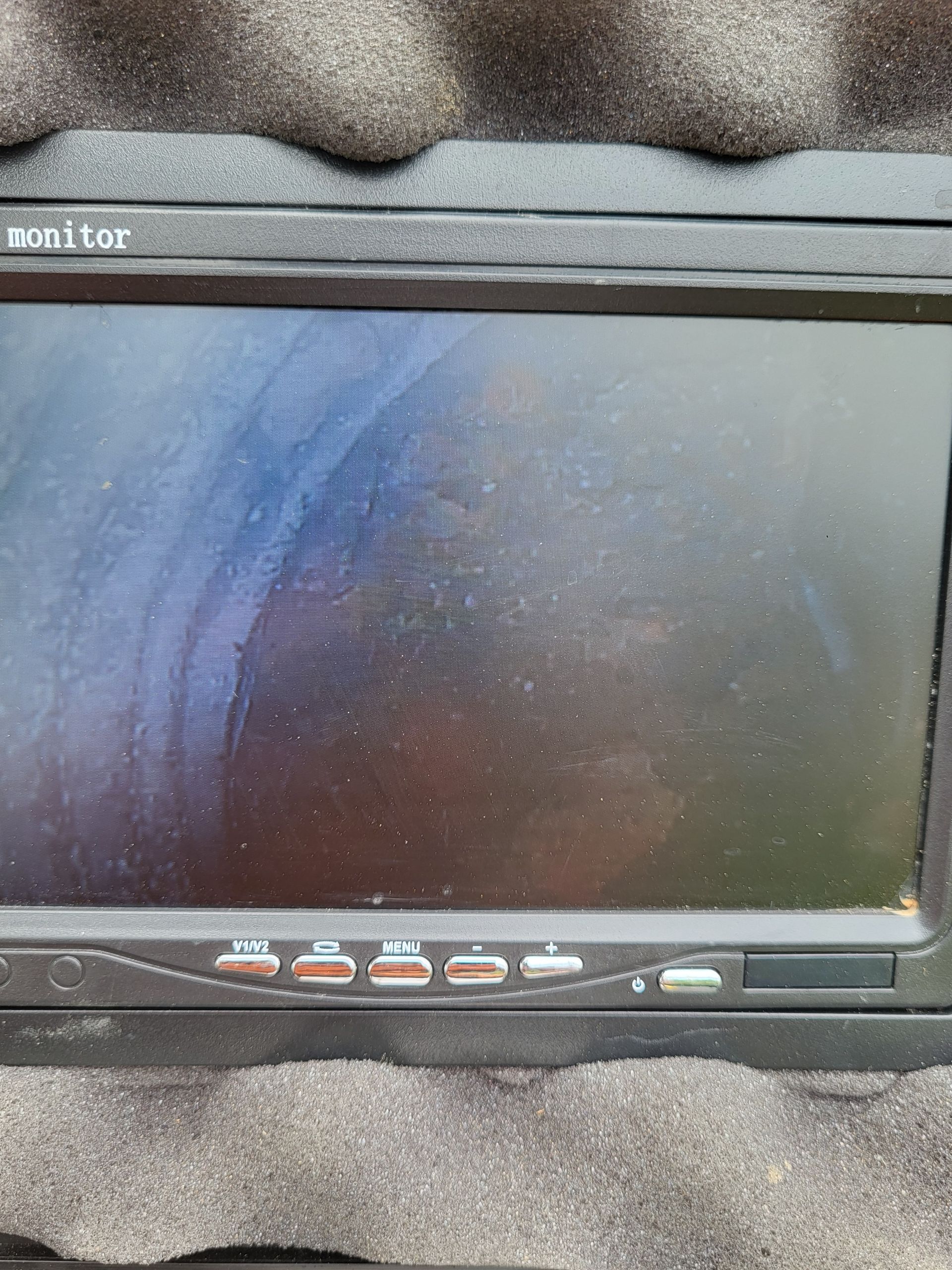 Black portable monitor with a blank screen and control buttons