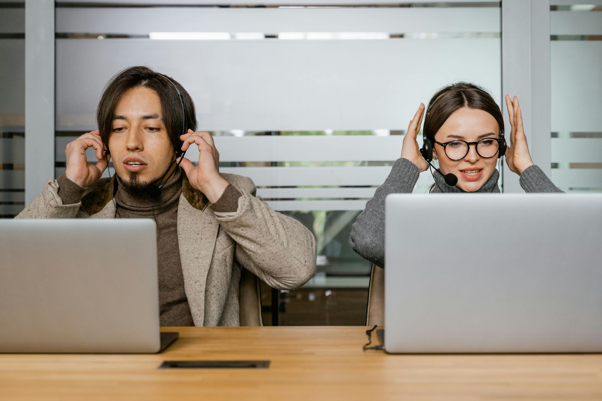 Two call center staff in headsets overwhelmed by high call volume at a medical practice