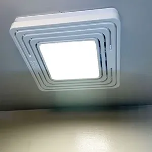 Square ceiling light with concentric white trim panels on a gray ceiling