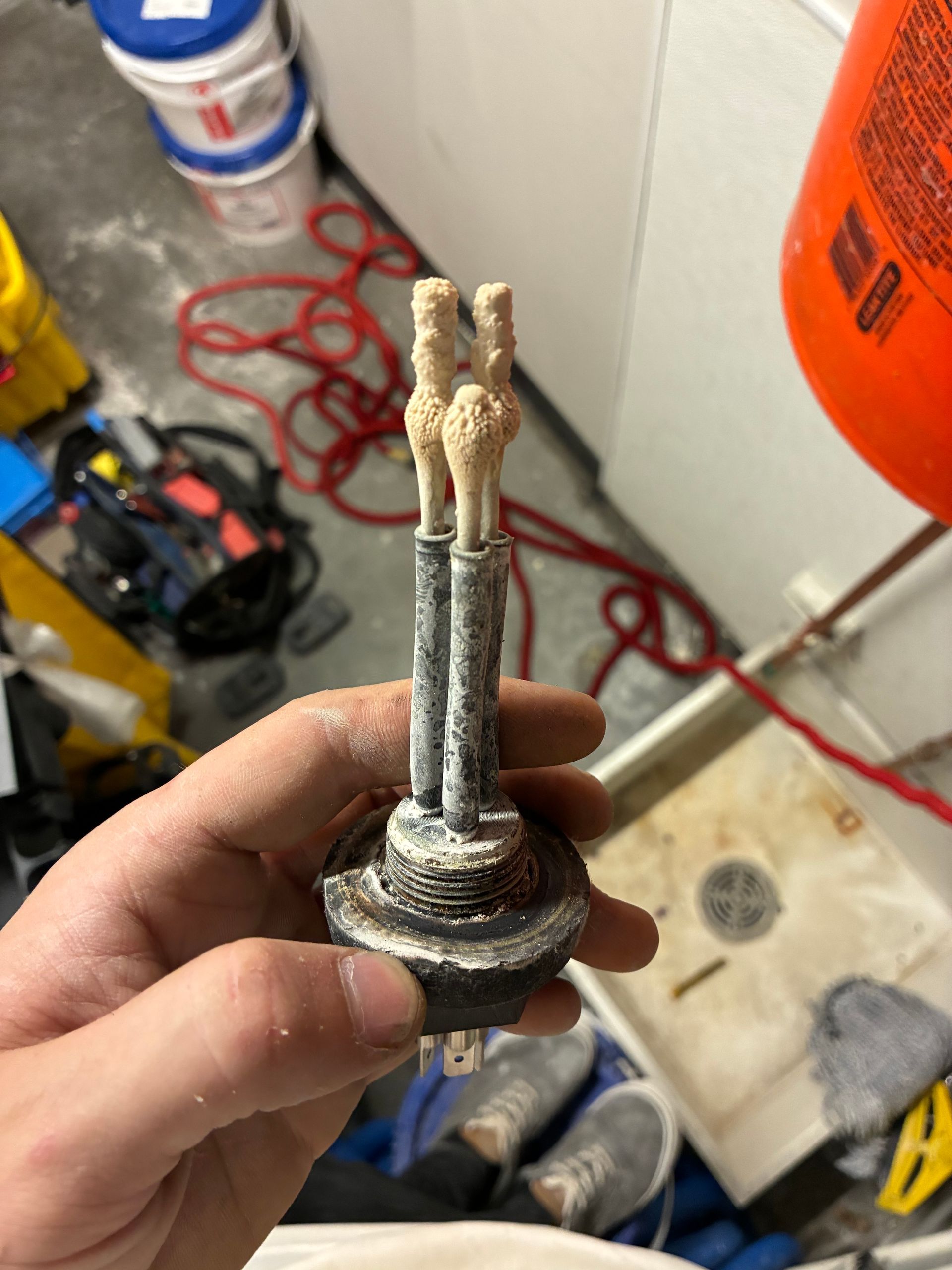 A person is holding a piece of metal in their hand
