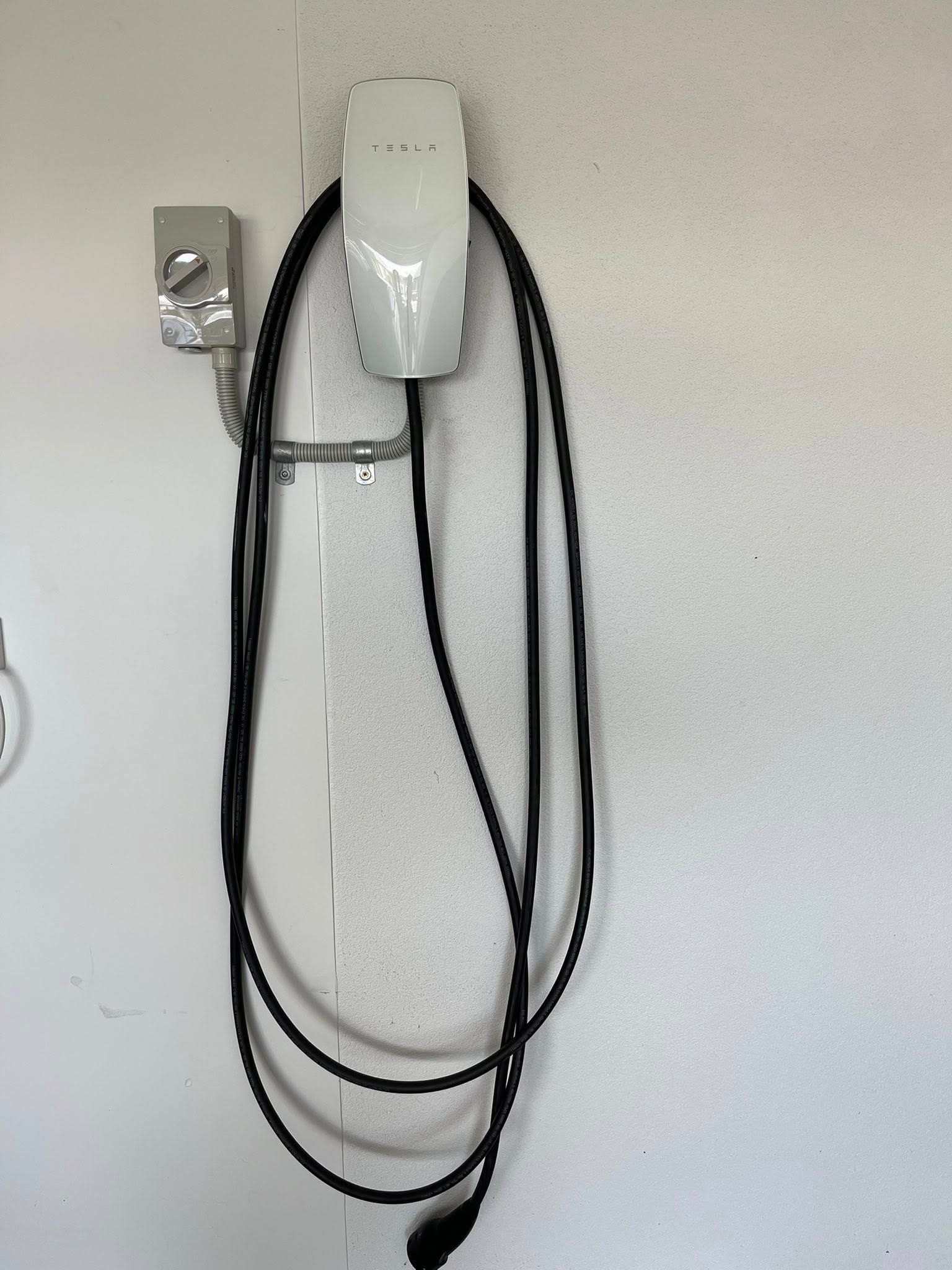 Wall-mounted White Device With Hanging Black Cords — Top Spark Electrical FNQ in Mission Beach, QLD