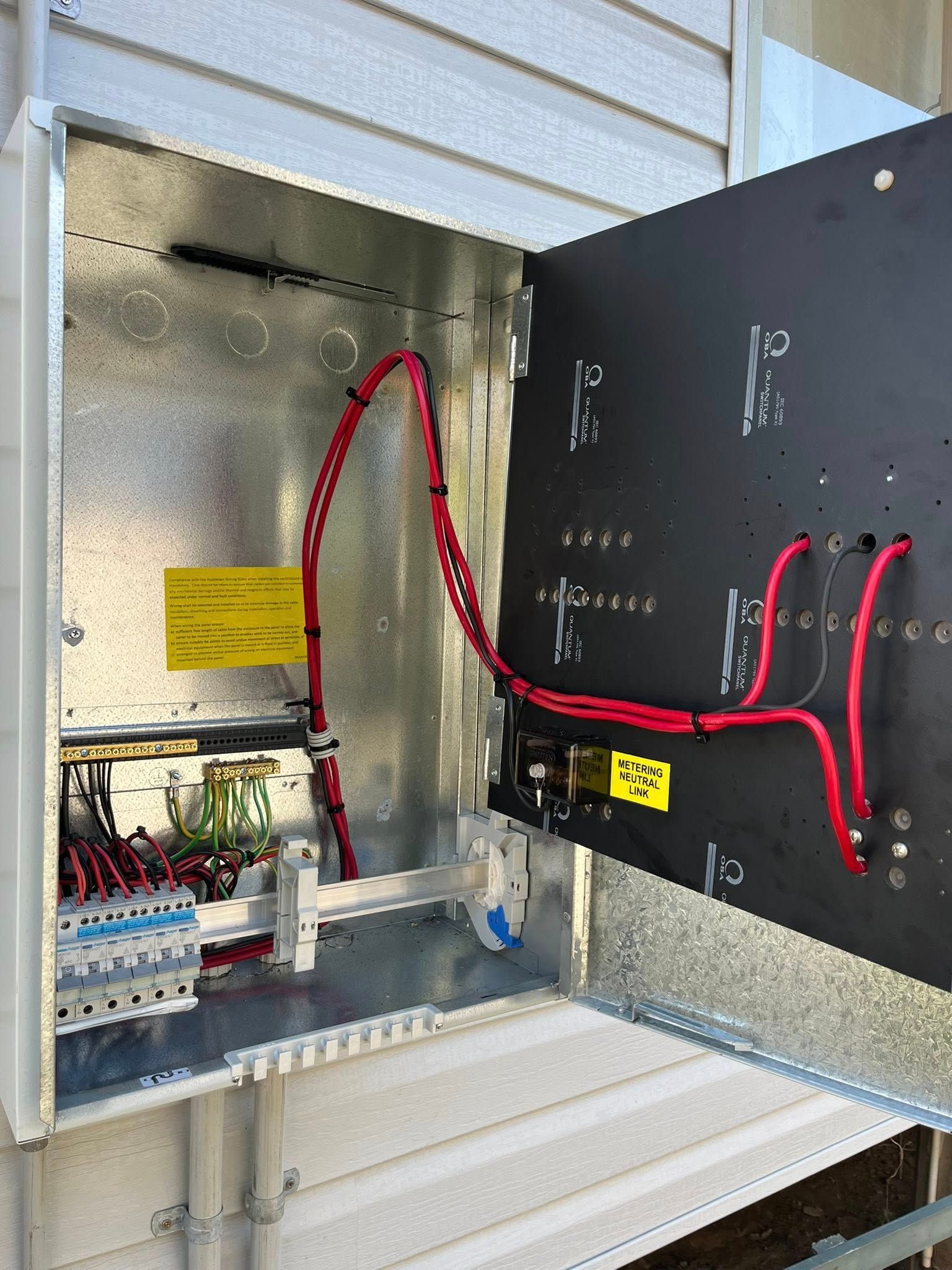 Open Electrical Panel With Red Wiring and Breaker — Top Spark Electrical FNQ in Innisfail, QLD
