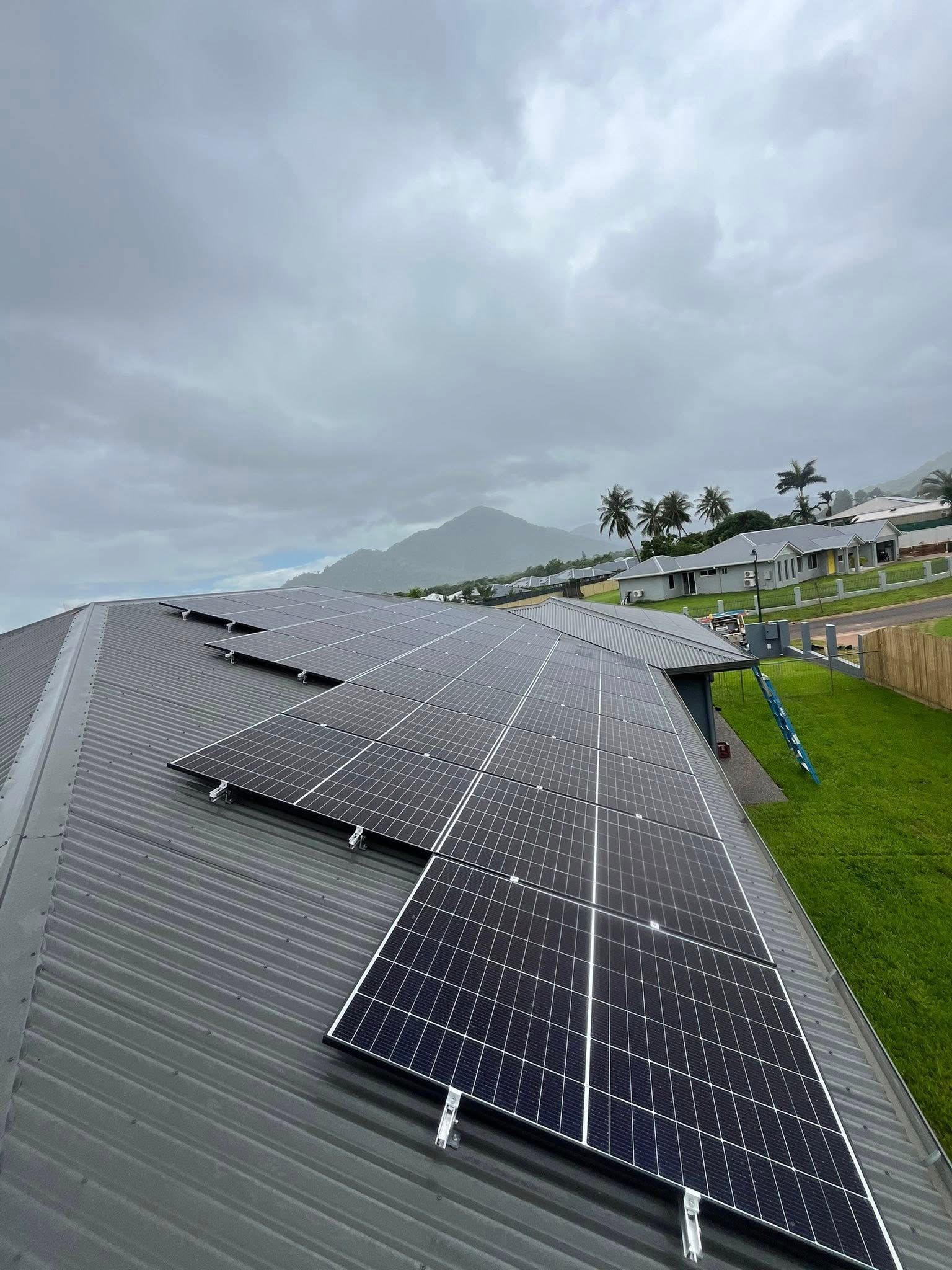 Solar Panels on a Rooftop Under Cloudy Skies — Top Spark Electrical FNQ in Innisfail, QLD