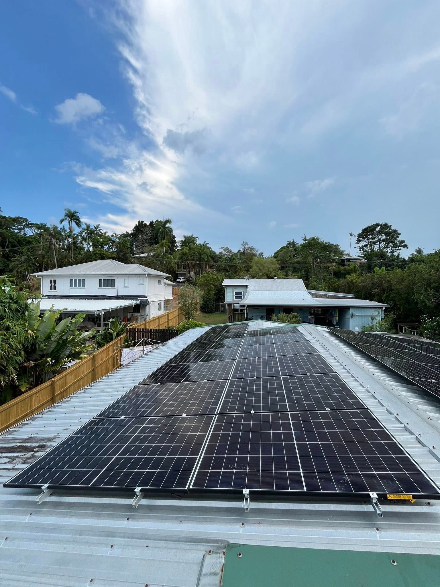 Large Rooftop Solar Panel Array Under a Blue Sky — Top Spark Electrical FNQ in Mareeba, QLD