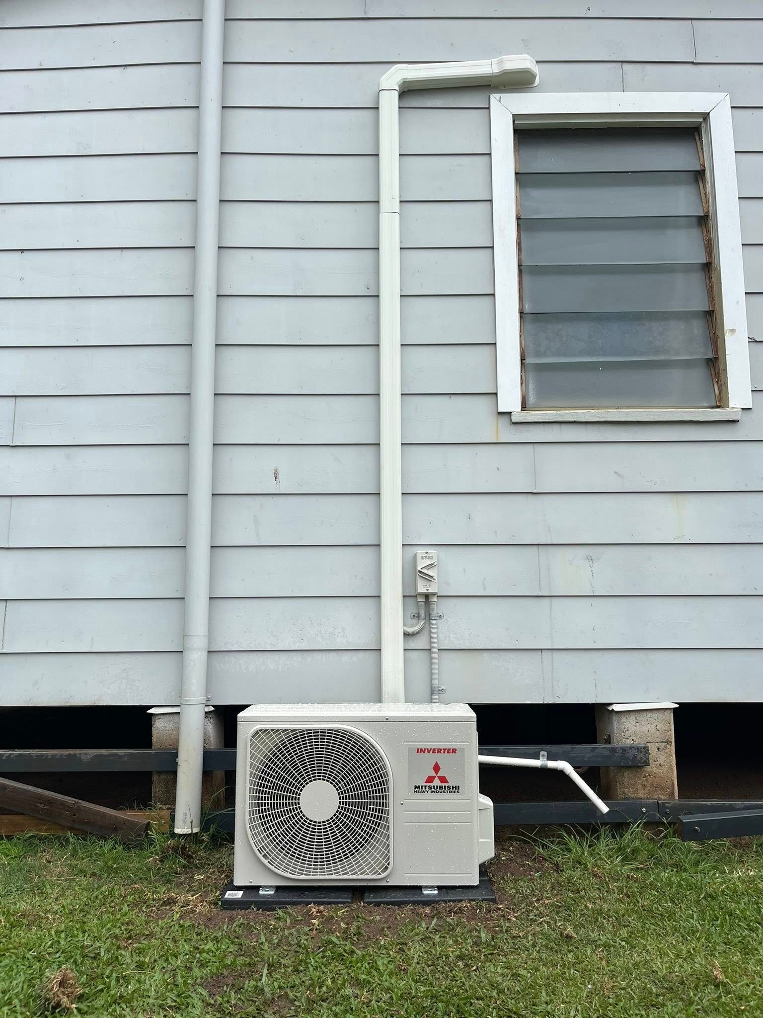 A House With a  White Pipe, and Air Conditioning Unit on the Ground — Top Spark Electrical FNQ in Innisfail, QLD