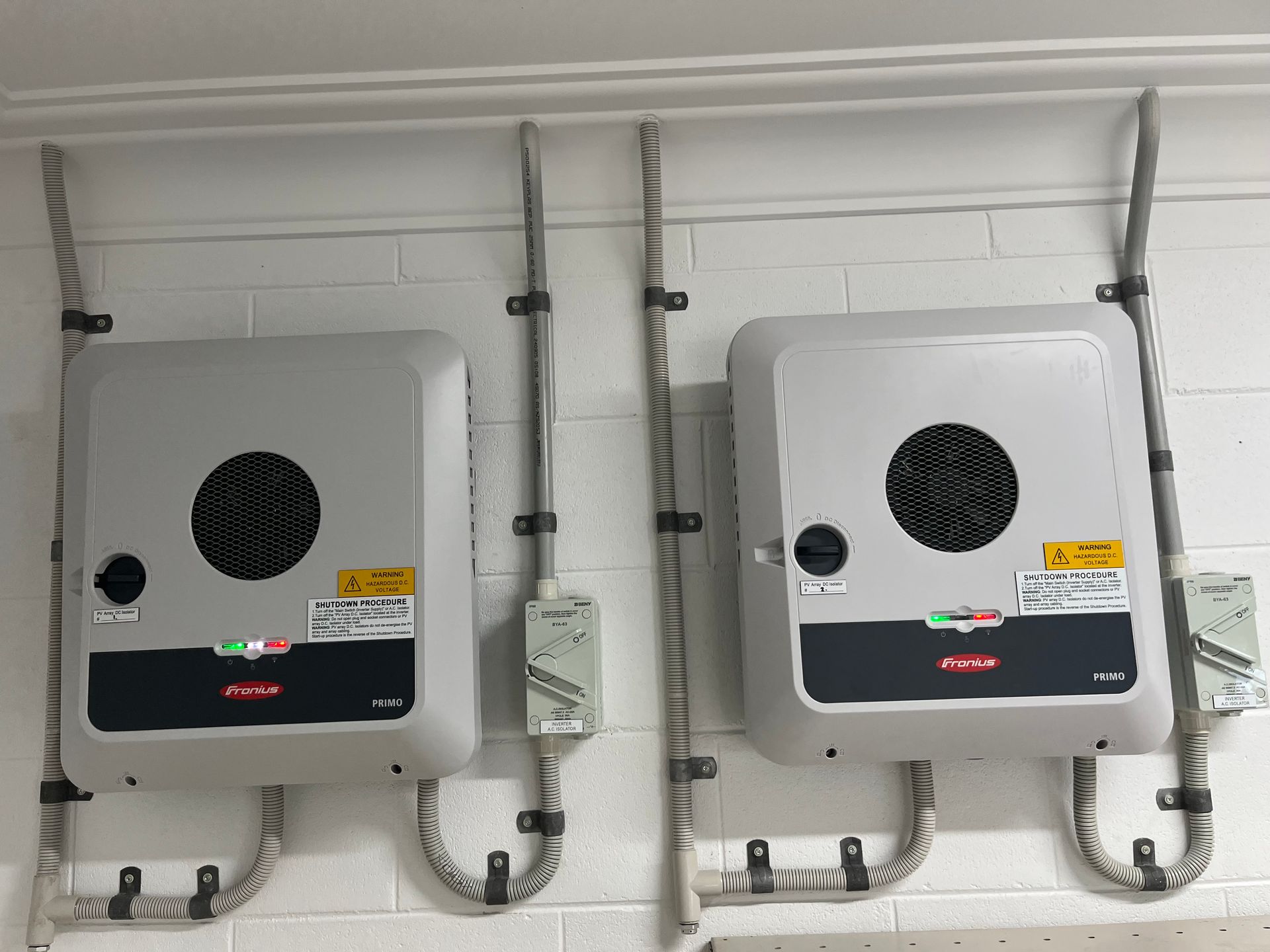 Wall-mounted White Utility Box With Pipes and a Small Control Panel — Top Spark Electrical FNQ in Malanda, QLD