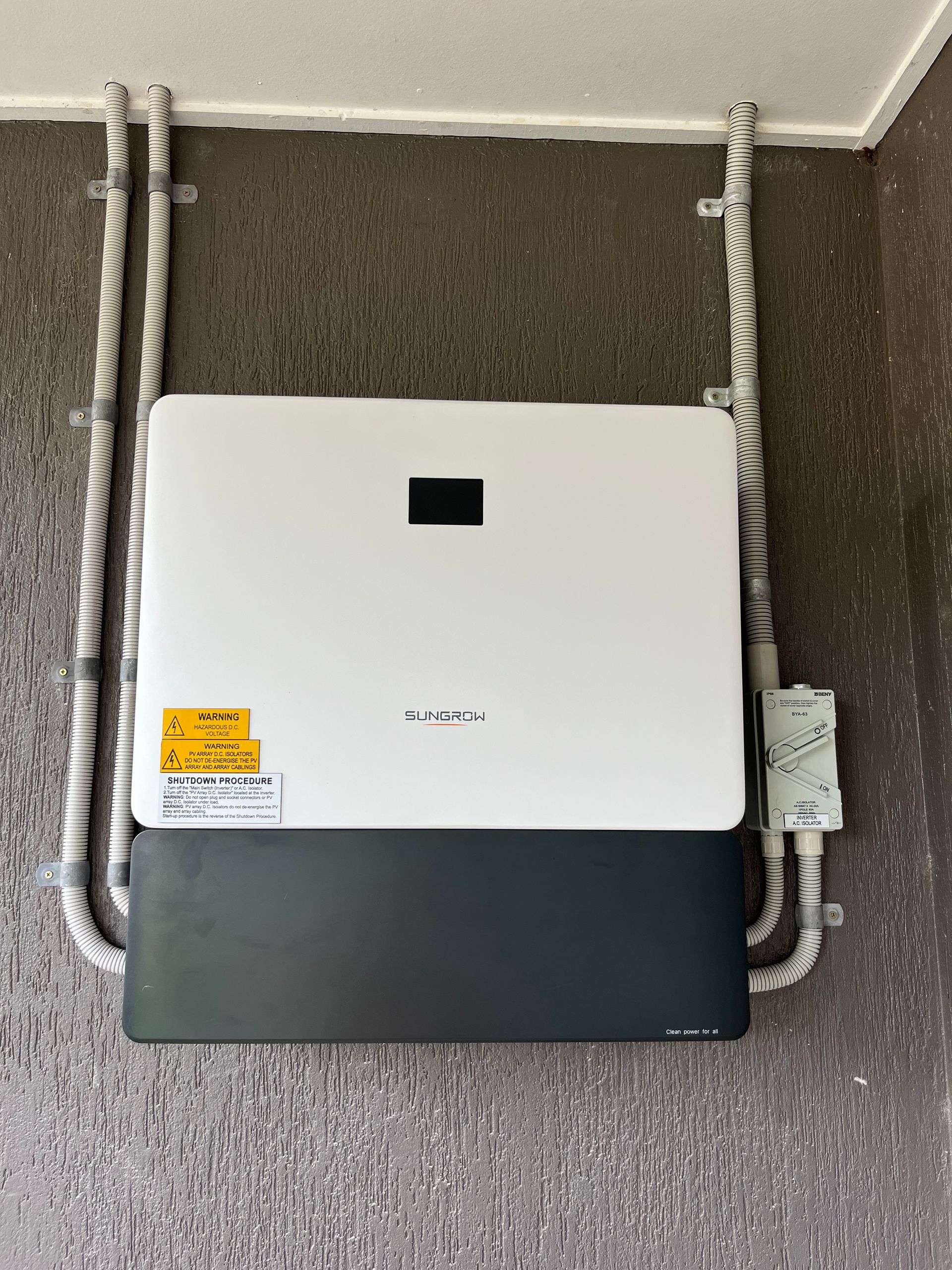 White Utility Box Mounted on House Siding With Exposed Pipes — Top Spark Electrical FNQ in Bayview Heights, QLD