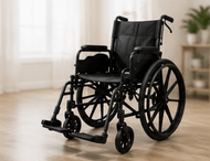 Red and black wheelchair with large rear wheels and footrests on a white background
