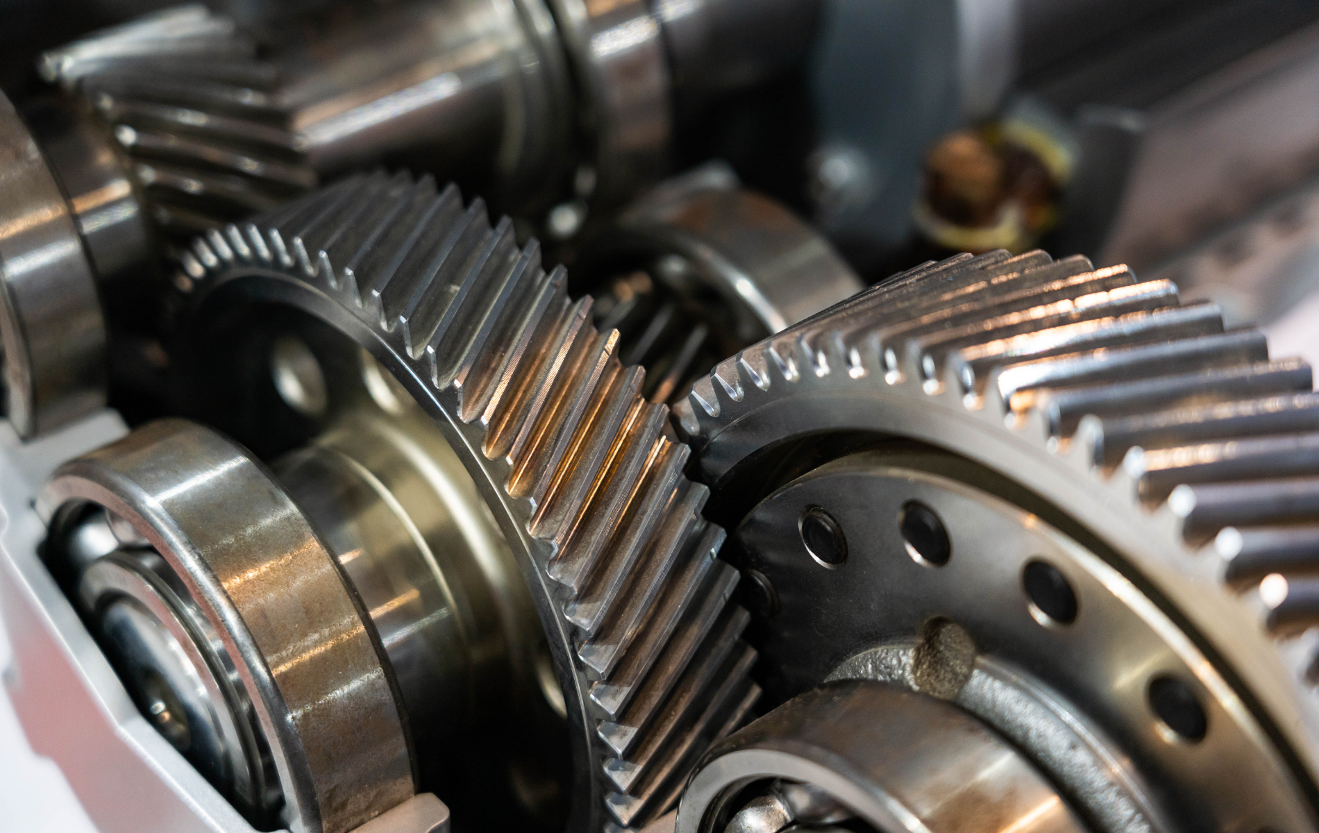 Close-up of shiny metal gears and bearings in a mechanical assembly