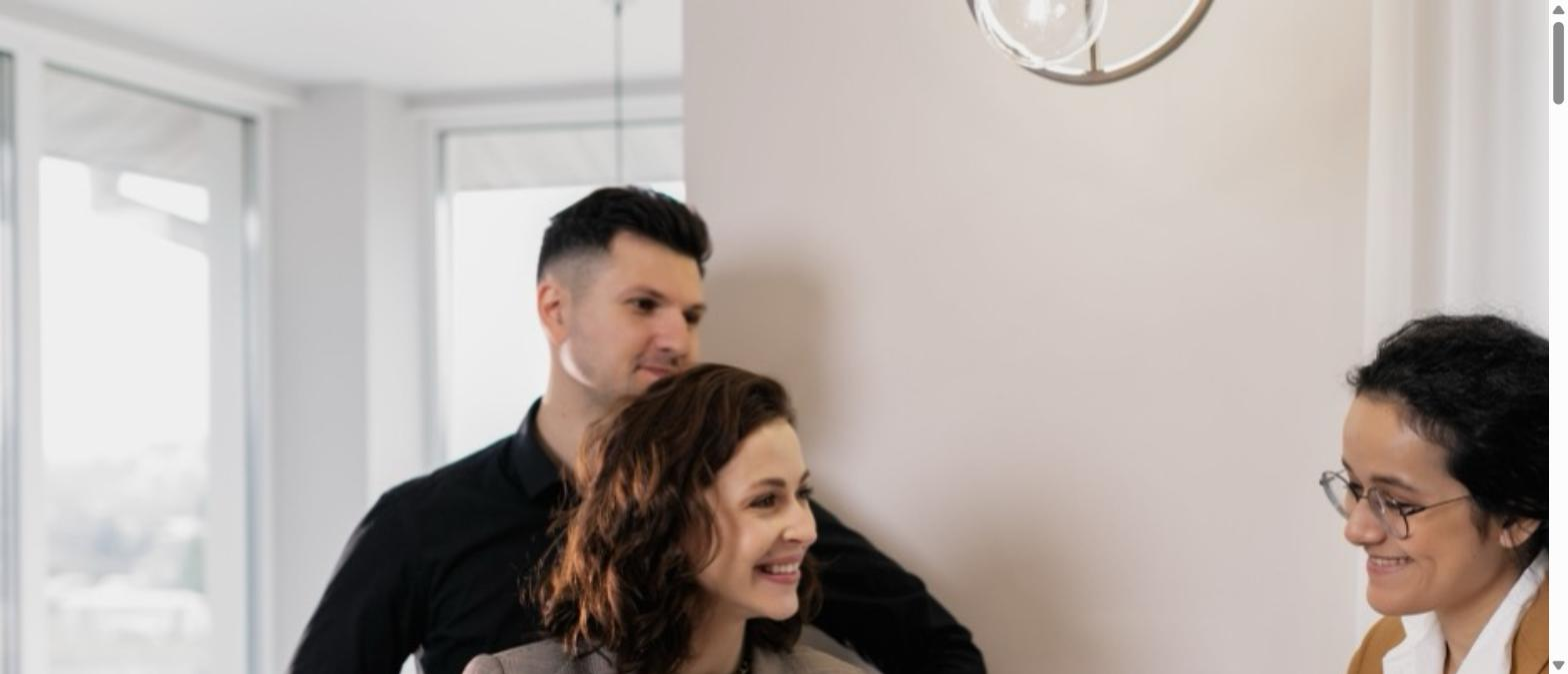 Couple meeting with a smiling insurance agent in a bright room