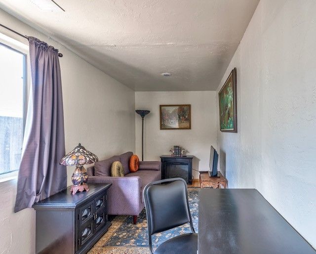 A living room with a couch and a desk