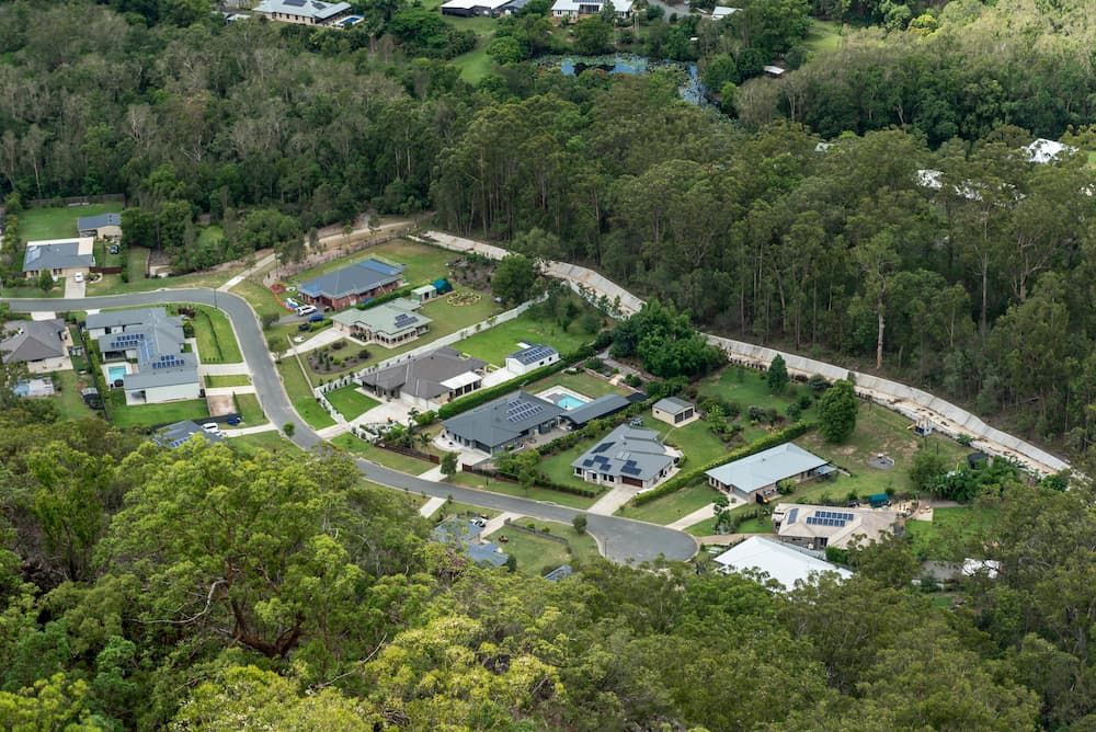 An Aerial View of A Residential Area Surrounded by Trees and Houses — Conveyor Maintenance Services In Home Hill, QLD