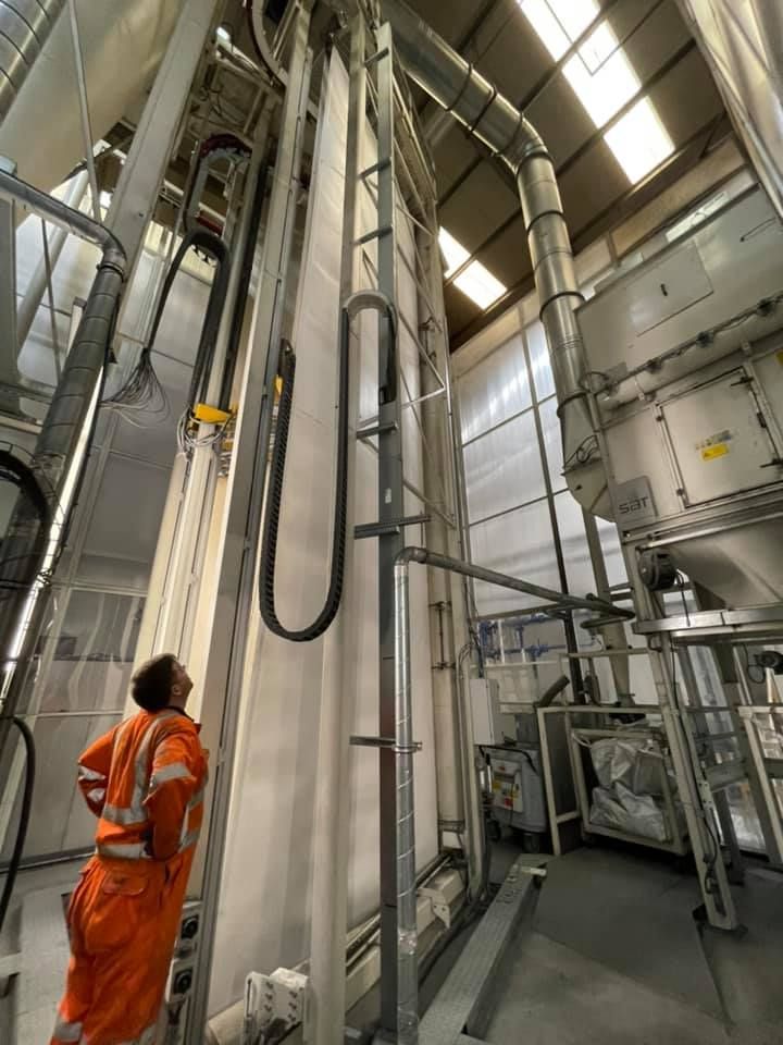Man Standing In Front Of Machine With Conveyor Belts — Conveyor Maintenance Services In Bohle, QLD