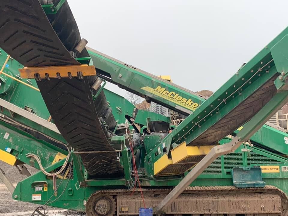 A Green and Yellow Machine with A Conveyor Belt Attached to It — Conveyor Maintenance Services In Charters Towers, QLD