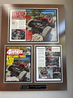 Framed collage of four 4 Wheel & Off-Road magazine covers on a brown display board