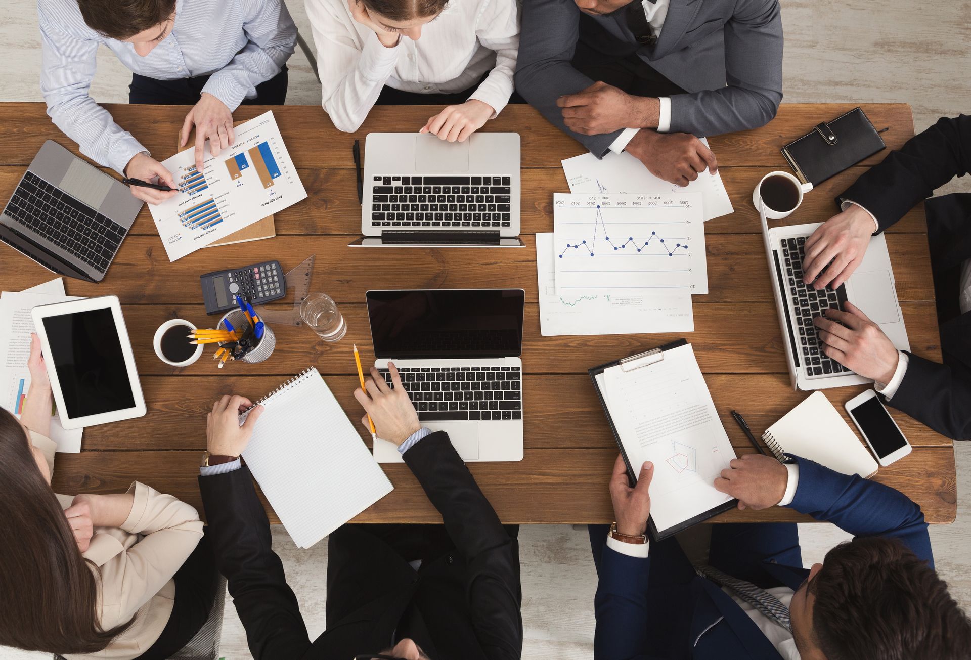 Diverse business team collaborating during a meeting around a conference table.