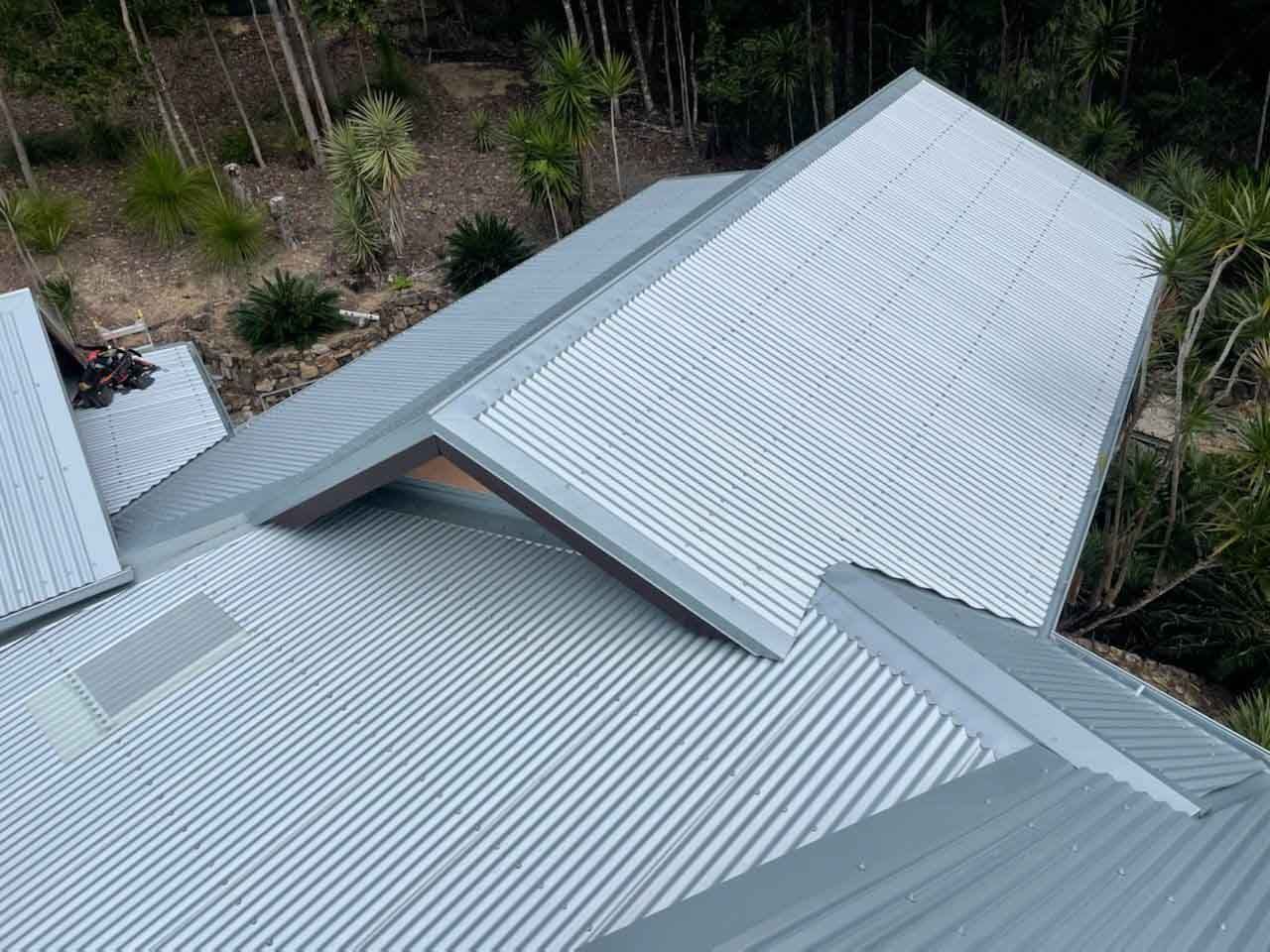 An Aerial View Of A Metal Roof With Trees In The Background — Posty’s Roofing In Airlie Beach, QLD