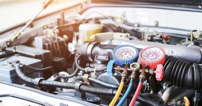 A close up of a car engine with gauges on it. A close up of a car engine with gauges on it.