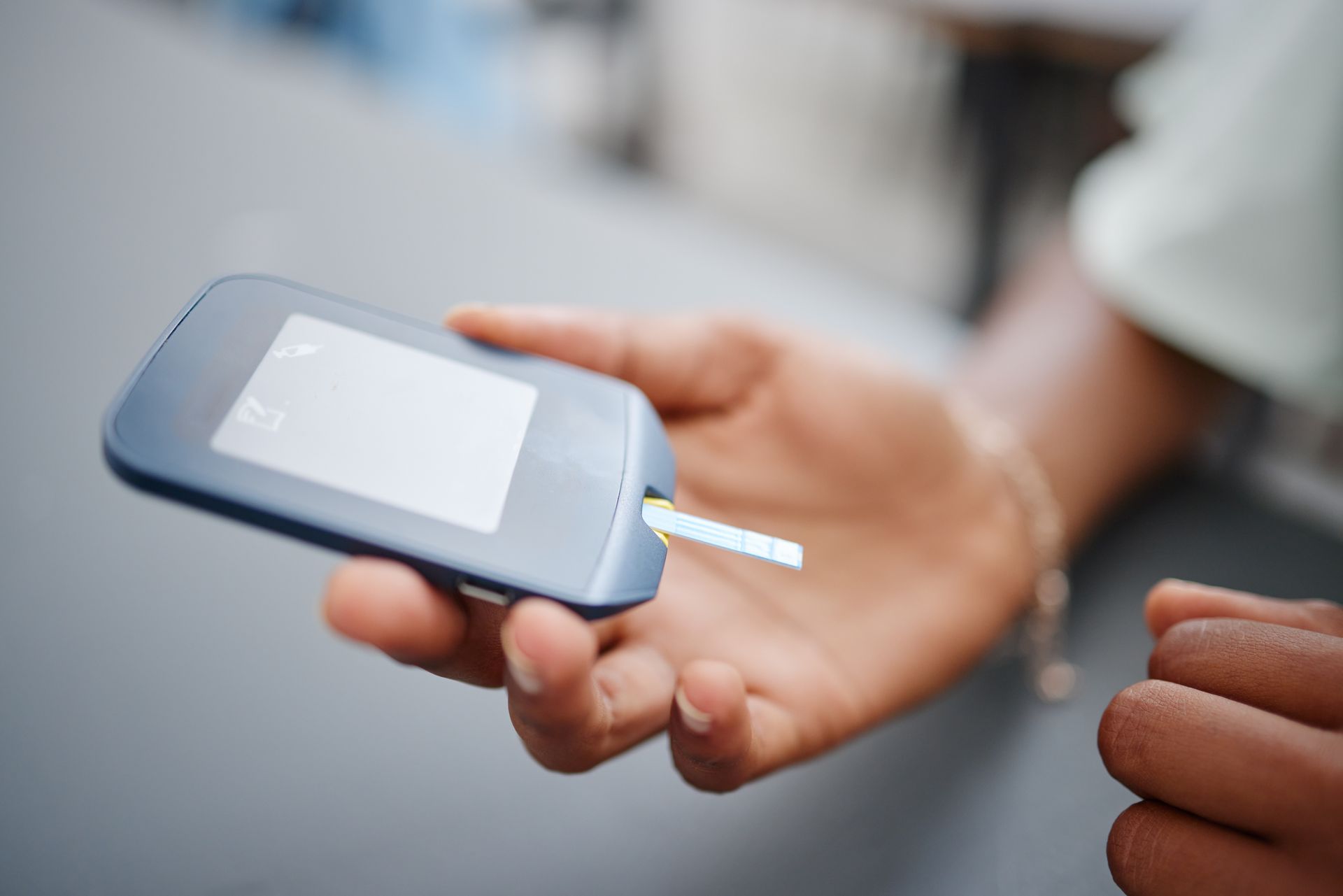 A person is holding a cell phone in their hand.