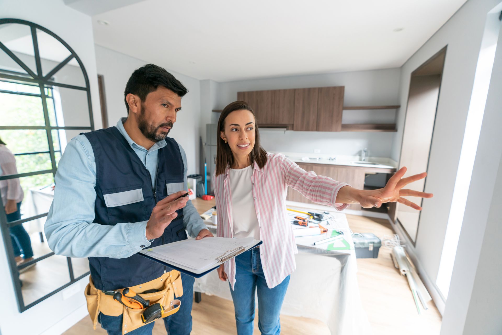 Home Addition Consultation in Maplewood, MN, with an APEX Design Build contractor discussing kitchen plans with a homeowner