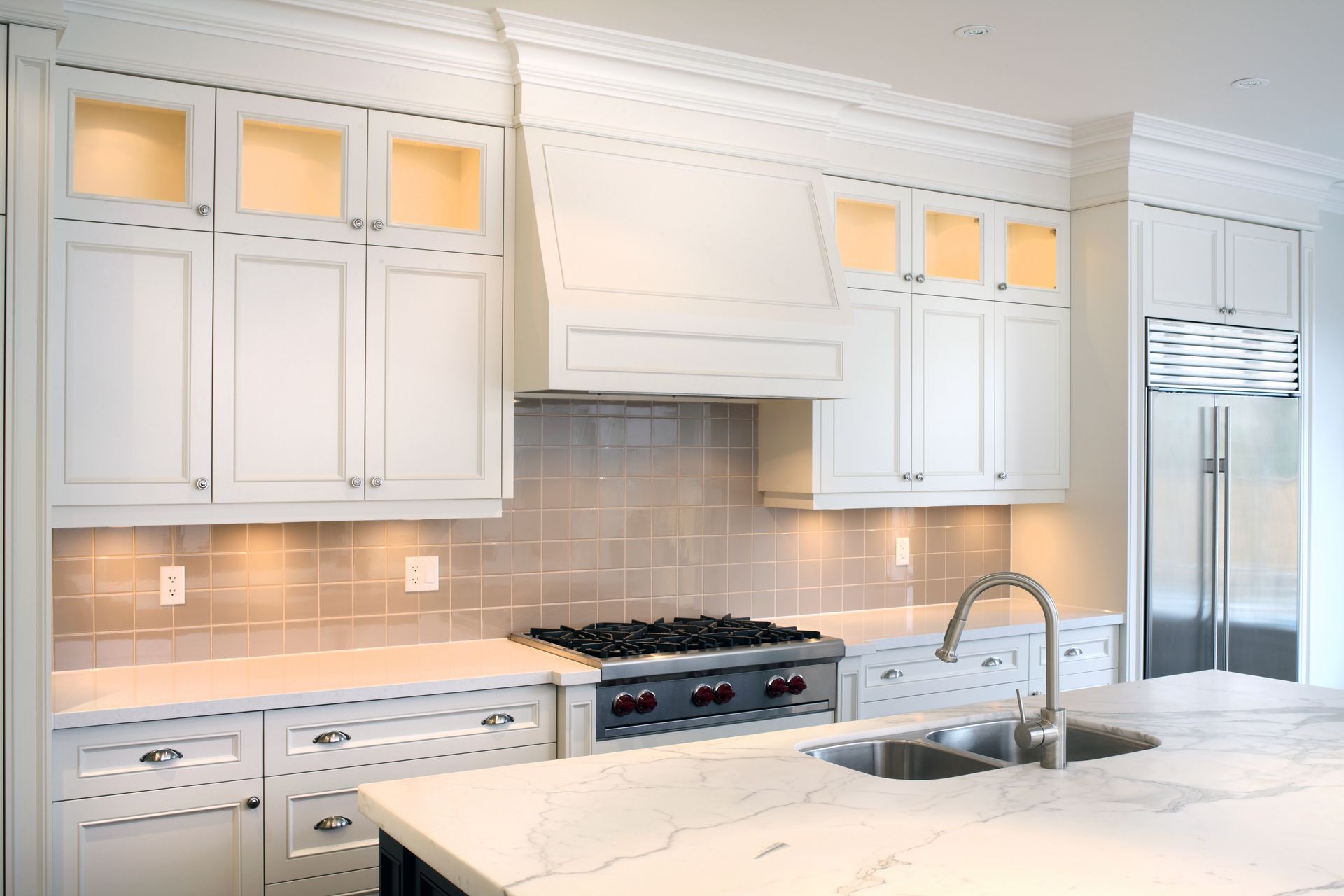 Granite countertops and two pendant lights above island