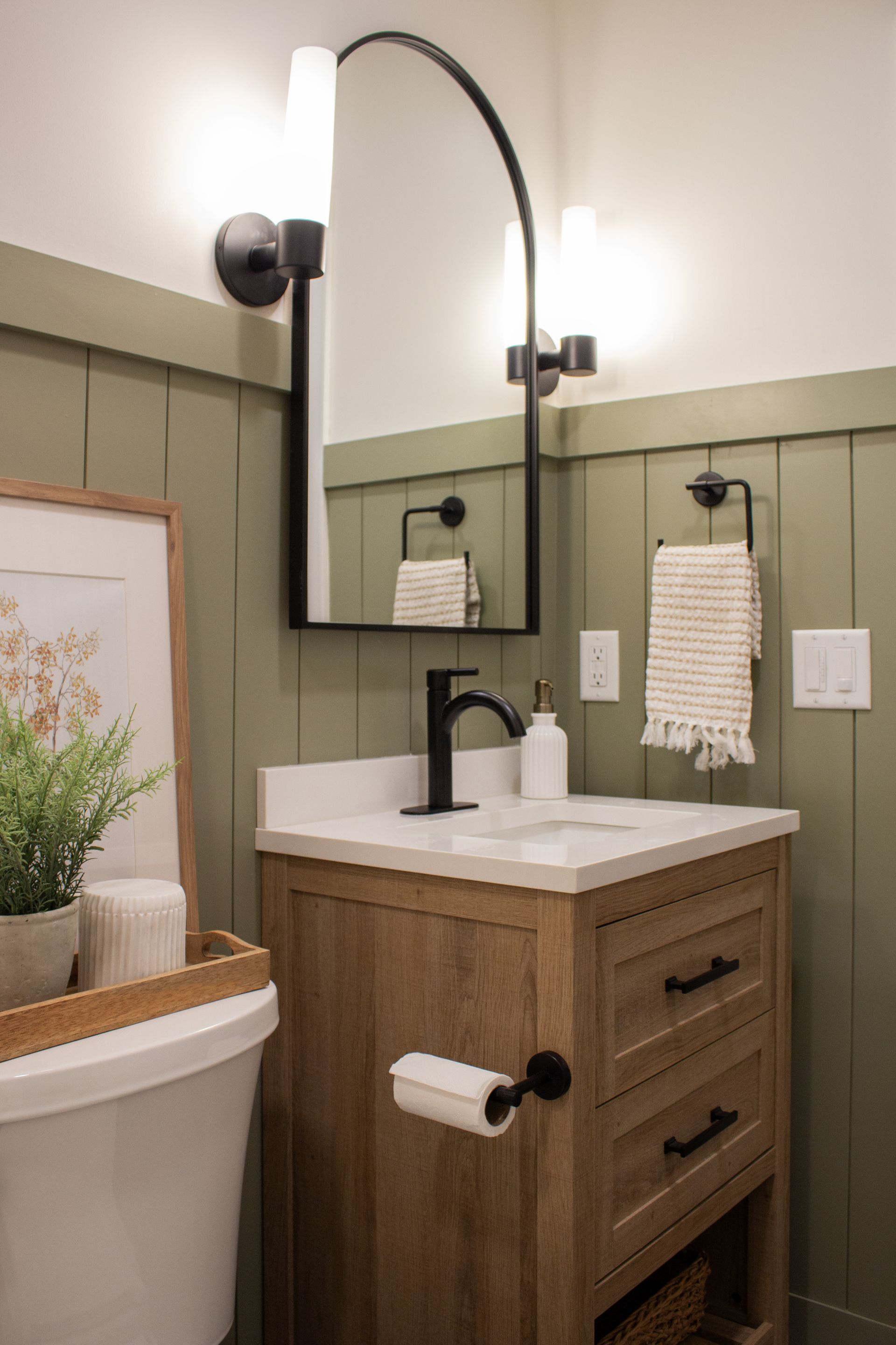 St. Paul bathroom remodeling project featuring updated vanity lighting and custom wall paneling