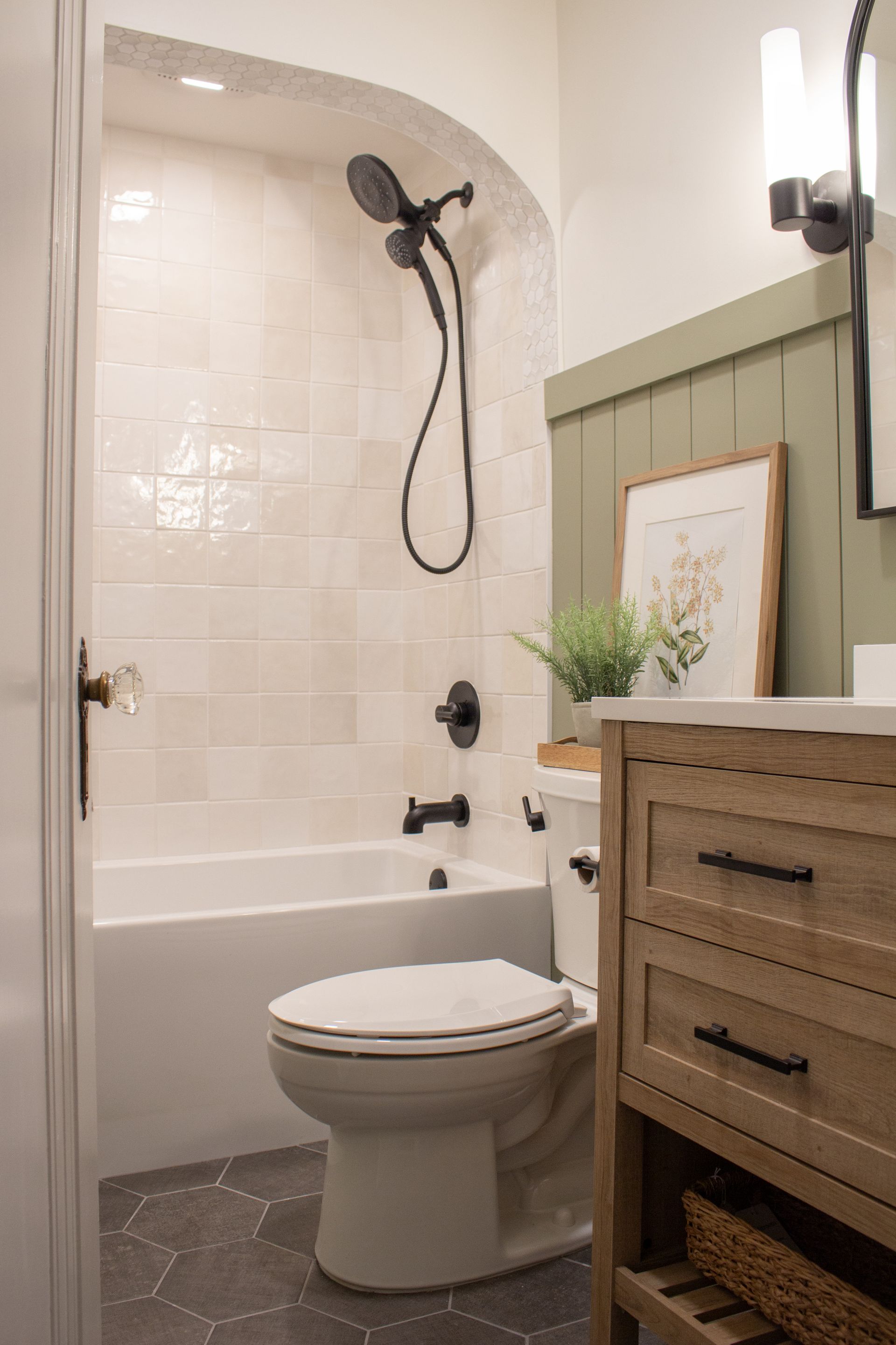 Bathroom remodeling project in St. Paul, MN featuring an arched tile shower alcove with matte black fixtures