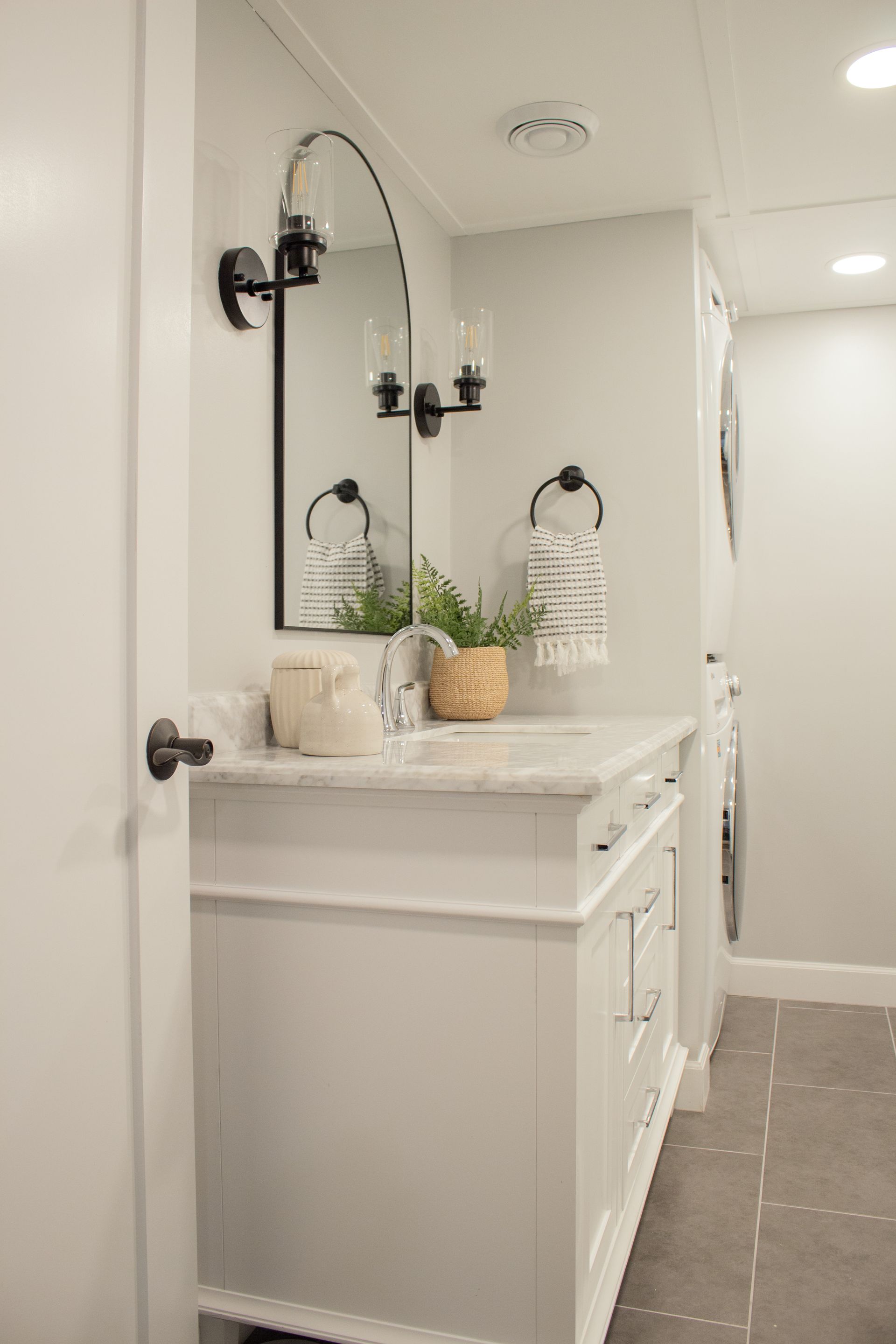 Bathroom remodeling in St. Paul, MN with modern mirror installation, updated lighting, and custom fixtures