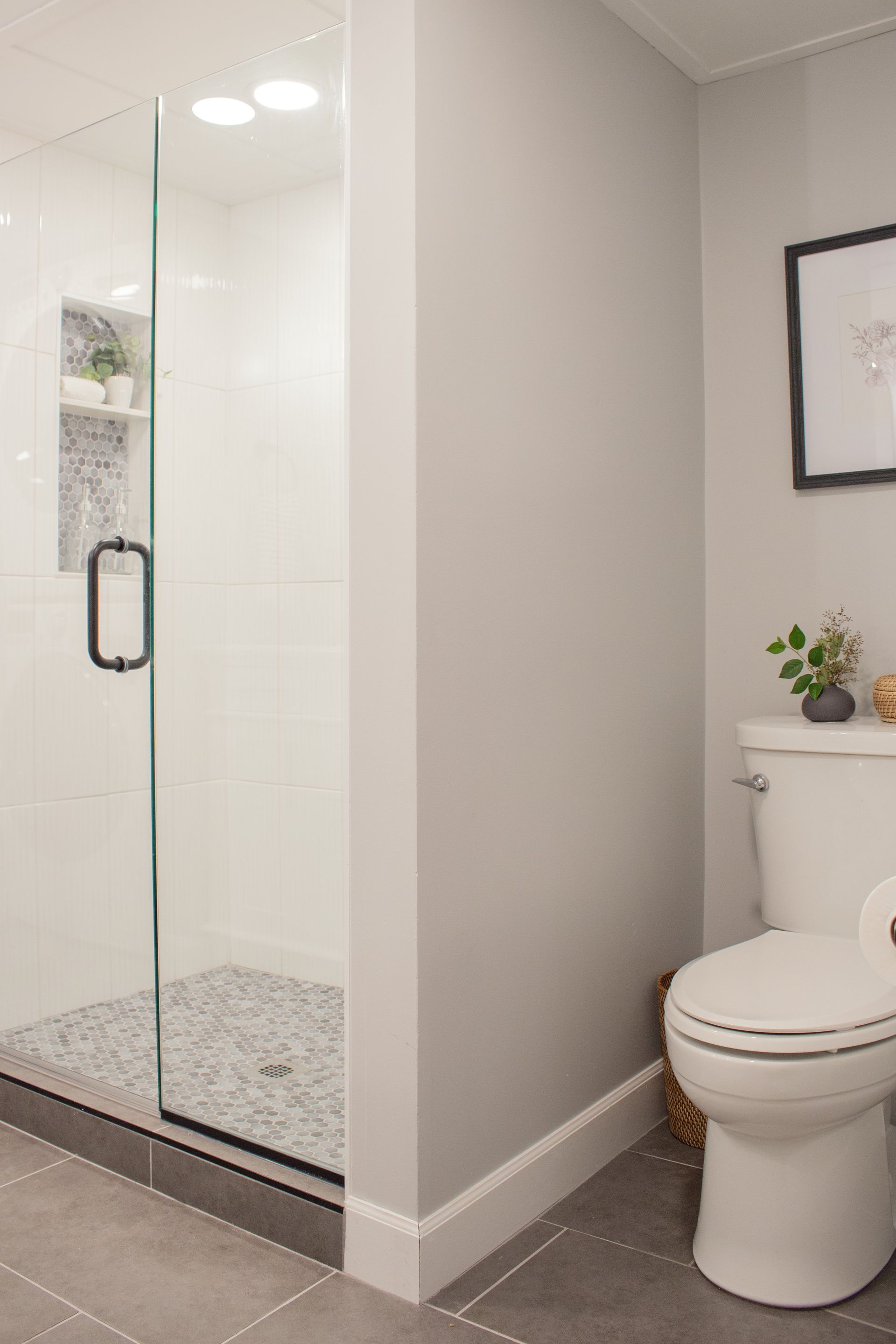 Custom bathroom remodel in St. Paul featuring a glass shower partition and contemporary interior design
