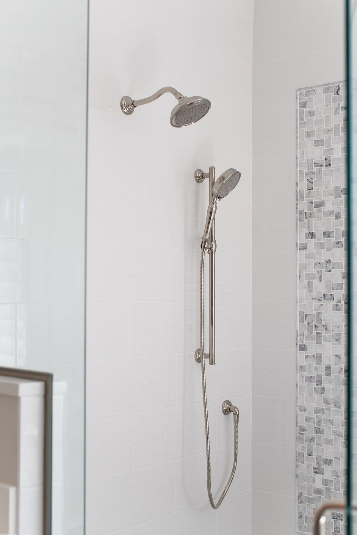 A Shower Head Is Hanging from The Wall in A Bathroom.