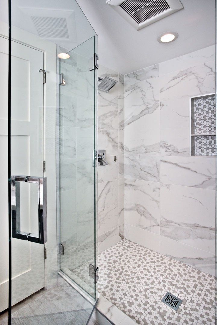 Bathroom remodel in St. Paul, MN featuring marble-look tile, frameless glass shower, and recessed lighting