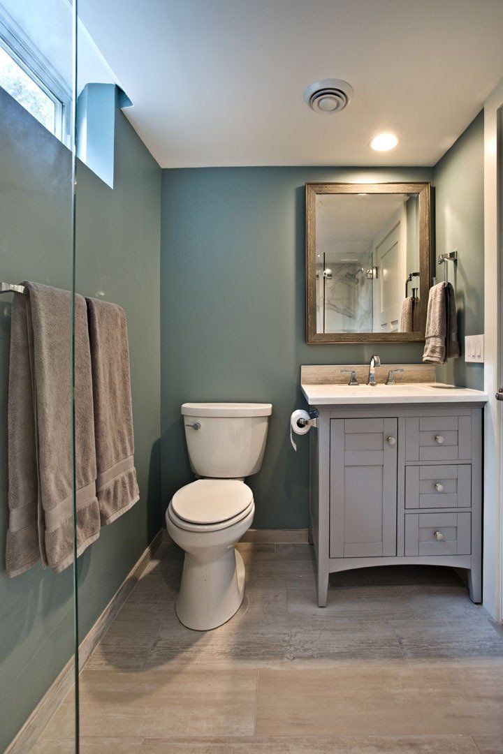 Bathroom remodeling project in Maplewood, MN featuring updated lighting, custom paint, and improved layout design