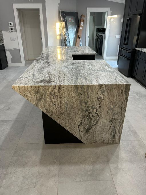 Granite kitchen island with waterfall edge in a modern home interior