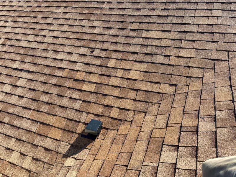 A close up of a roof with a person standing on it.