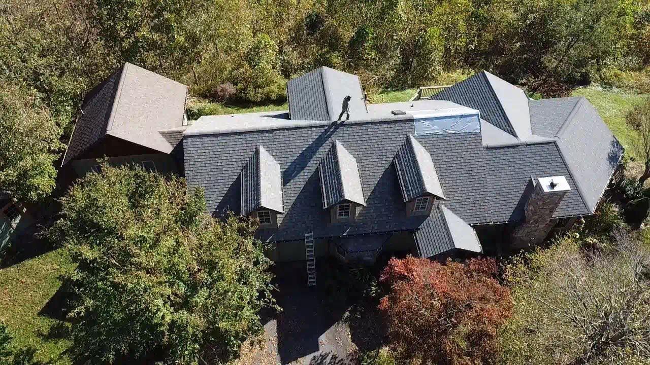 An aerial view of a large house surrounded by trees.