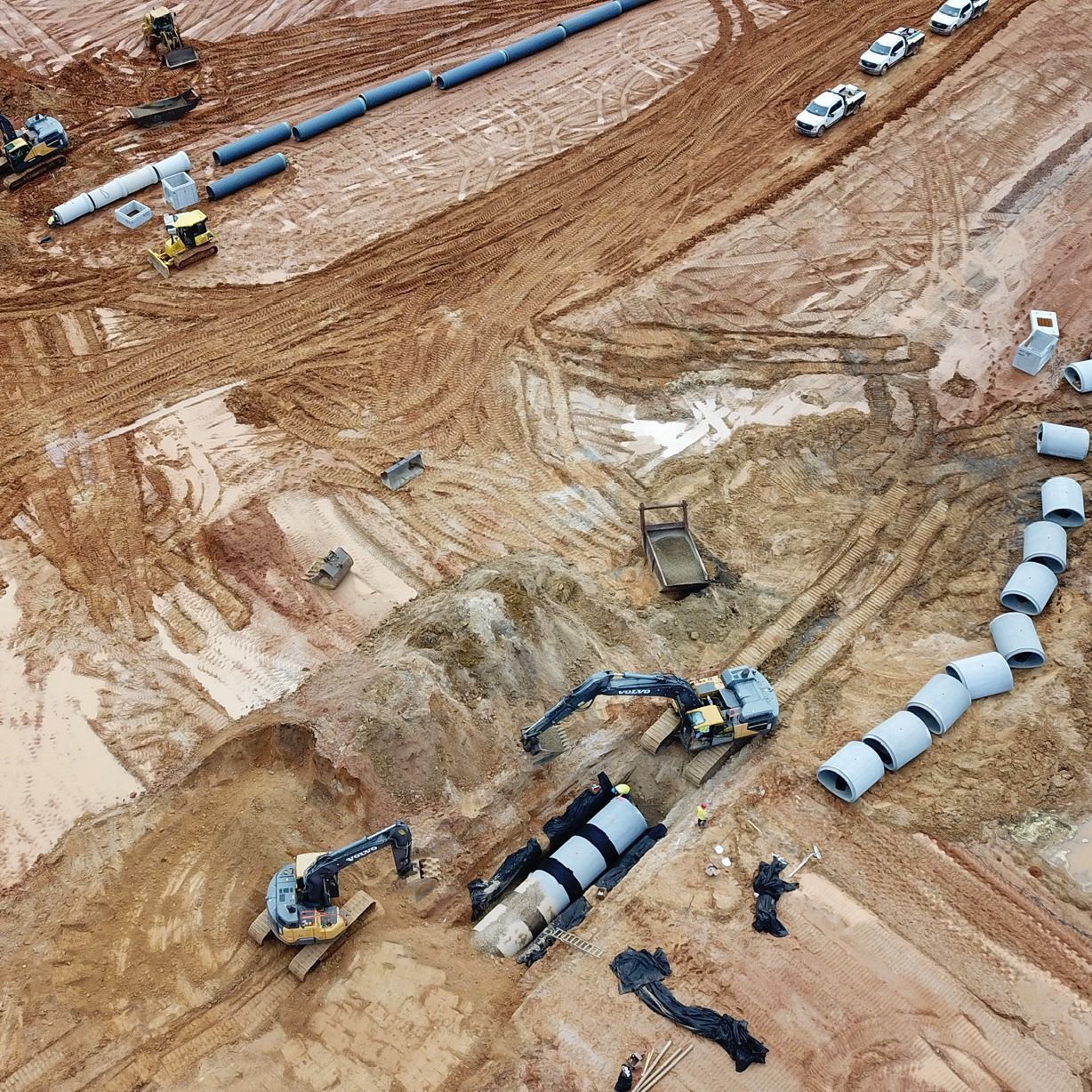 An aerial view of a construction site with pipes and machinery.
