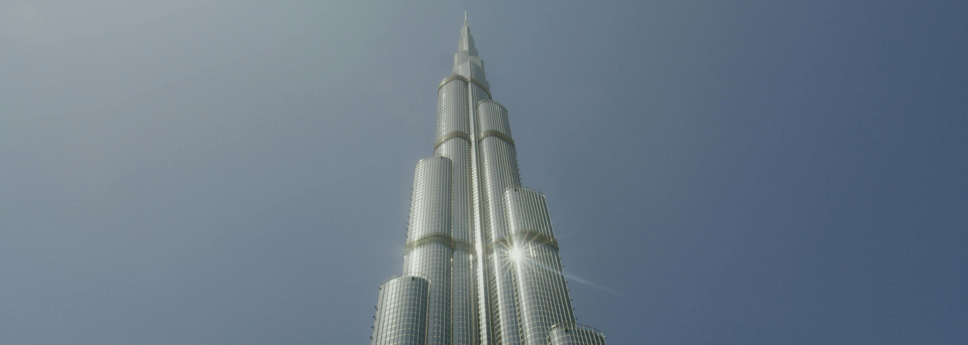 The Burj Khalifa skyscraper against a clear blue sky.