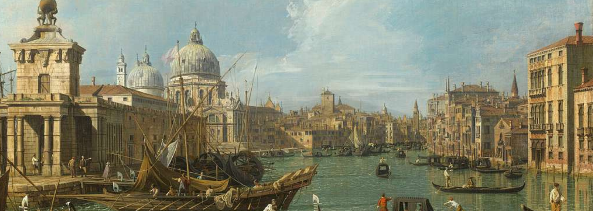 View of Venice with boats on water and buildings along the canal.