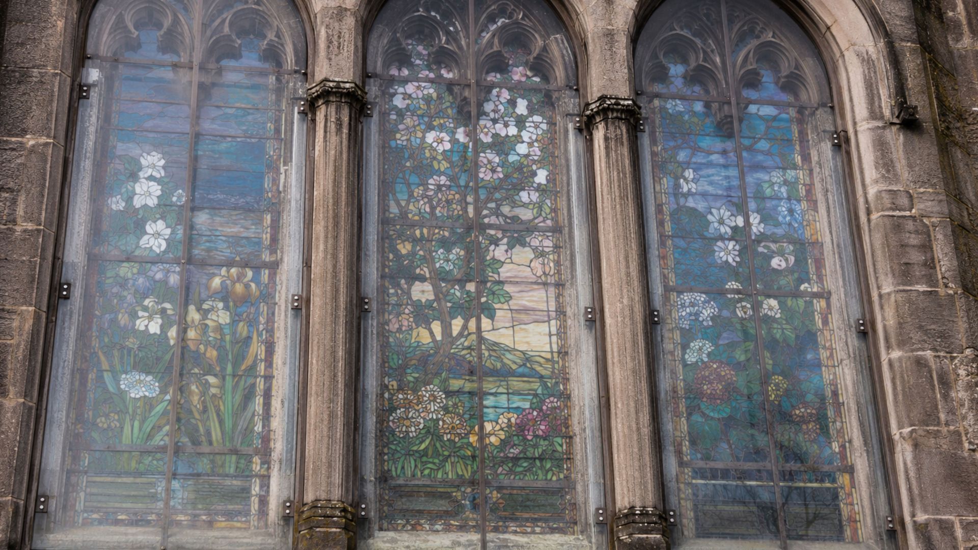 How can secondary glazing help preserve historical stained glass? 