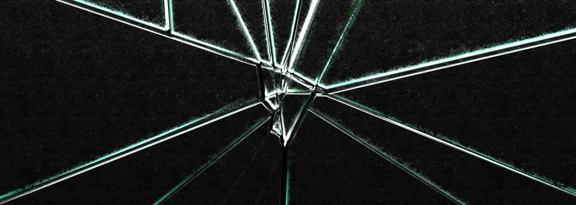Cracked glass with sharp, white lines against a dark background, suggesting impact.