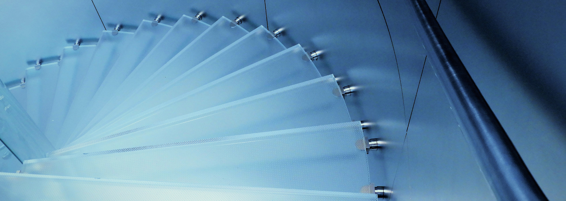 Glass spiral staircase in shades of blue.